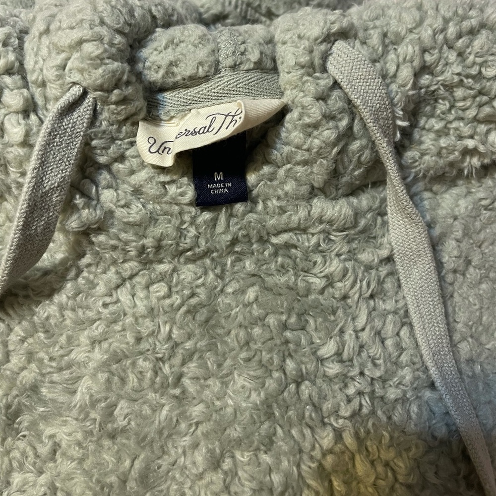 Fluffy, warm, light gray hooded pullover.